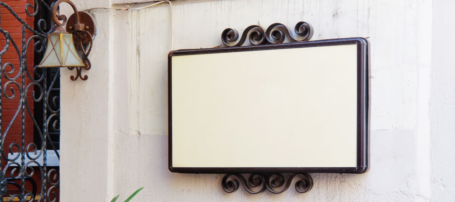 A mirror hanging on the wall with a black frame.